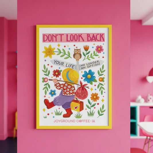Framed Mary Engelbreit x Joyground Coffee Don't Look Back poster with colorful illustration and text on a pink wall