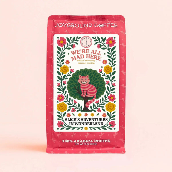 We're All Mad Here Makin' Me Crazy Caramel Vanilla naturally flavored coffee from Joyground Coffee - pink bag with Cheshire Cat from Alice in Wonderland
