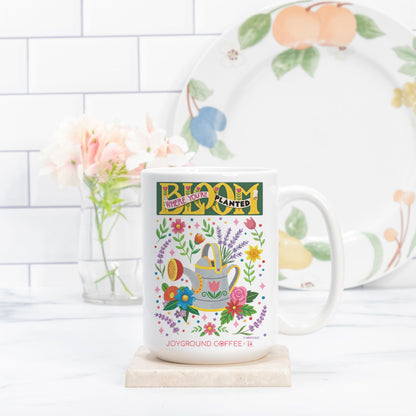 Joyground Coffee Mary Engelbreit white ceramic Bloom Where You're Planted mug on a kitchen counter