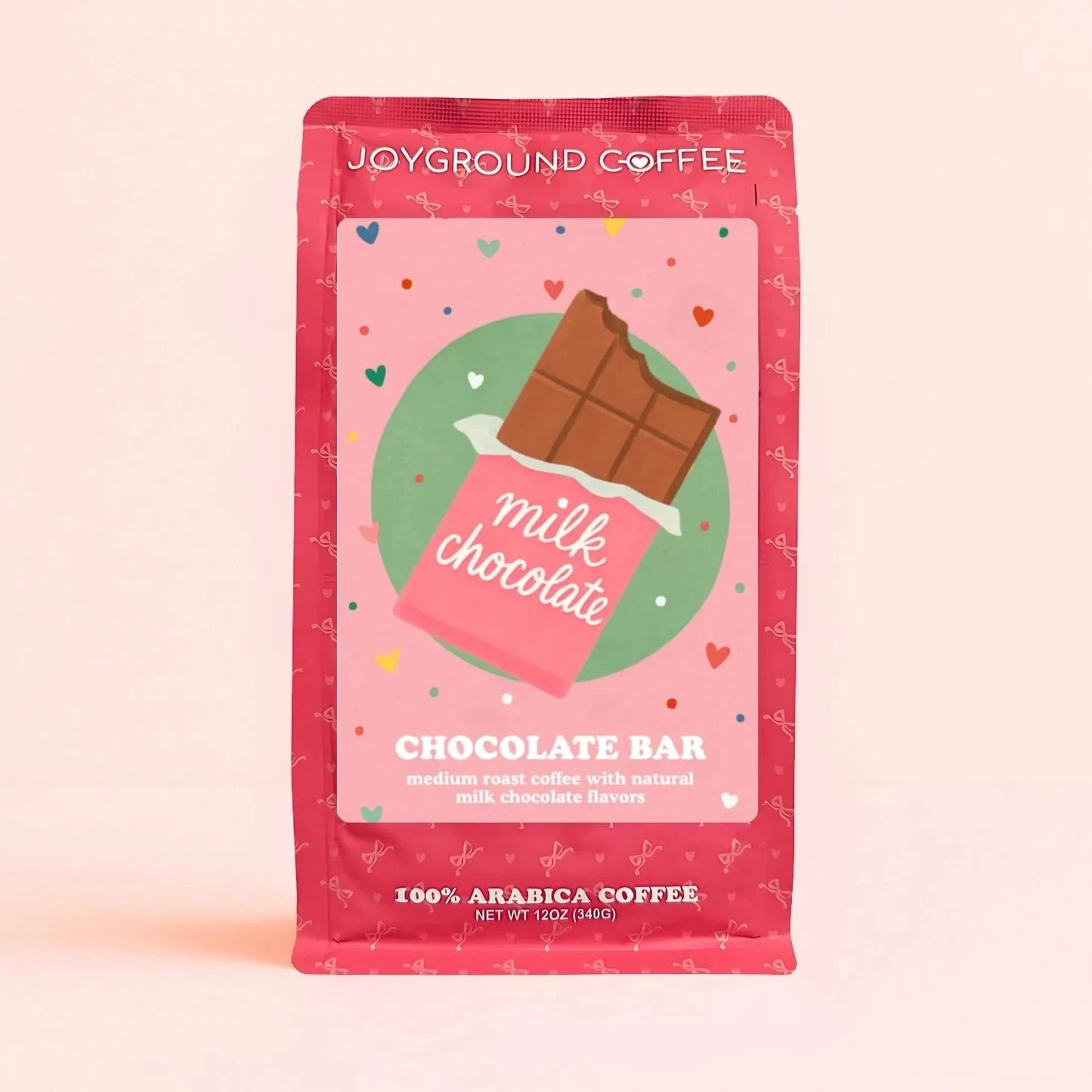 Chocolate Bar Joyground Coffee front packaging featuring a milk chocolate candy bag on a pink bag. 