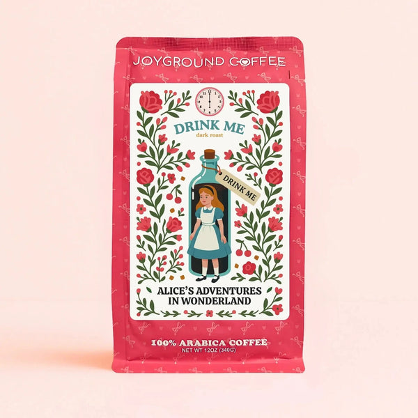 Alice in Wonderland Drink Me Dark Roast themed pink coffee bag from Joyground Coffee