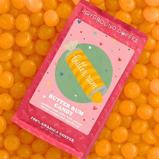Butter Rum Candy Joyground Coffee packaging on a pile of butter rum candies.