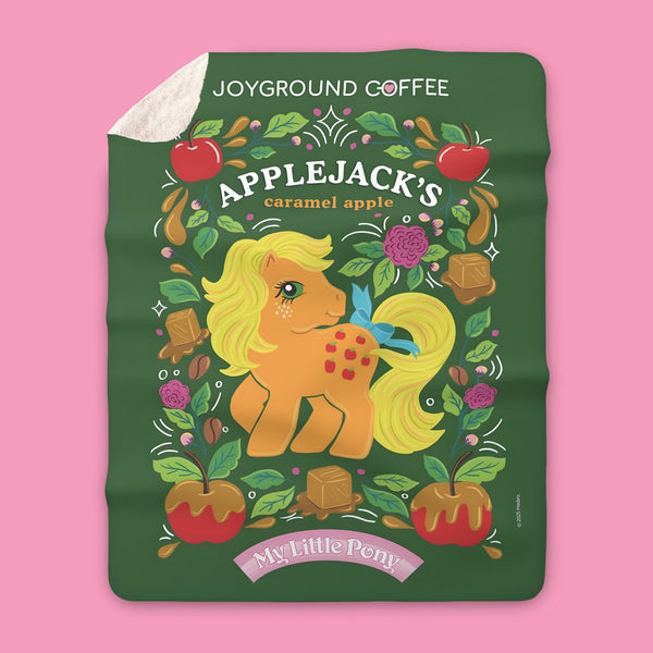 Joyground Coffee x My Little Pony sherpa feece blanket featuring MLP G1 Applejack on a pink background