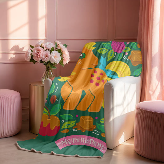 Colorful 'My Little Pony' Applejack blanket from Joyground Coffee draped over a chair in a room with pink walls and decor.