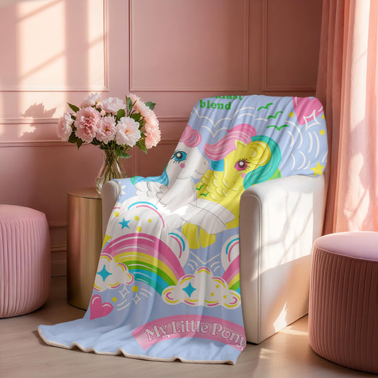 Colorful 'My Little Pony' Starshine and Skydancer blanket draped over a chair in a room with pink walls and decor.