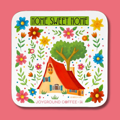 Coaster with a house, tree, and flowers on a pink background, featuring 'Home Sweet Home' text.