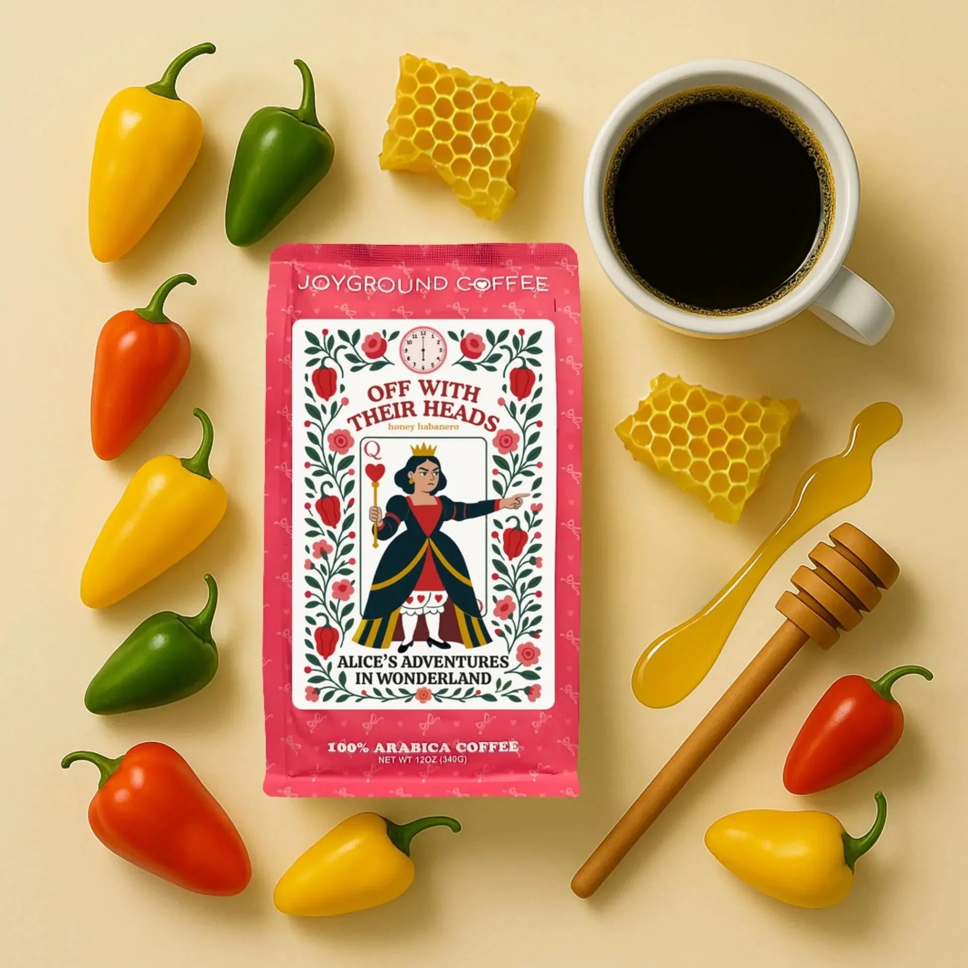Off With Their Heads Joyground Coffee bag next to a white coffee mug, honey comb, and red, green, and yellow peppers.