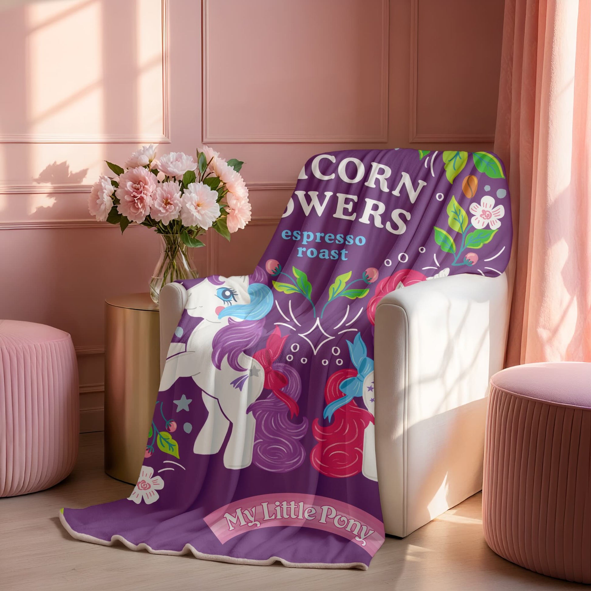 Purple 'My Little Pony' blanket draped over a chair in a room with pink walls and flowers.