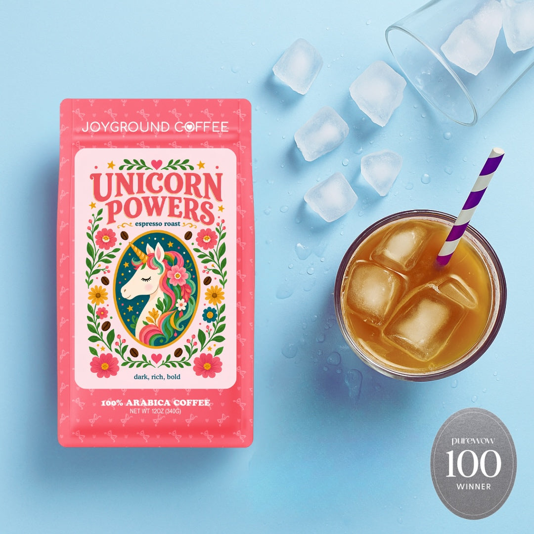 Joyground Coffee 'Unicorn Powers' package with a cup of iced coffee on a blue background