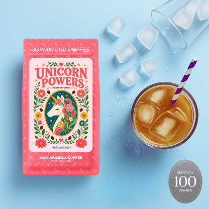 Joyground Coffee 'Unicorn Powers' package with a cup of iced coffee on a blue background